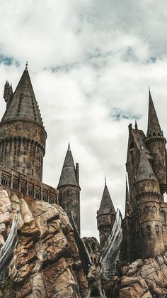 an image of a castle on top of a rock formation that looks like it's going to fall down