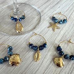 three wine glasses with gold seashells and blue beads