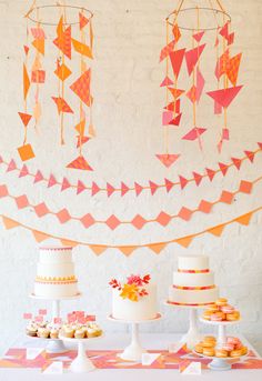 a table topped with lots of cakes and cupcakes