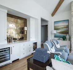 a living room filled with furniture and a fire place under a painting on the wall