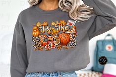 a woman wearing a sweatshirt that says tis the season with pumpkins and leaves on it