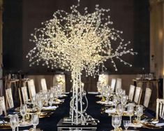 the centerpiece is decorated with white flowers and branches