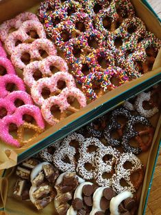 two boxes filled with different kinds of donuts