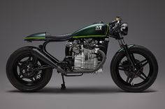 a green and black motorcycle on a gray background