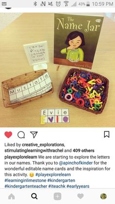 a wooden table topped with lots of magnets next to a book and box filled with letters