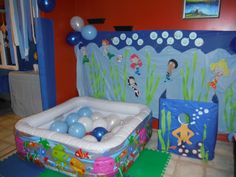 an inflatable pool with balloons on the floor