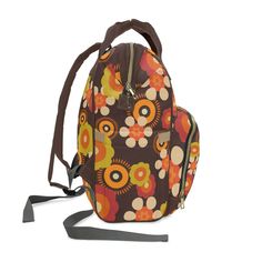 Show off your far-out style with this retro funky floral backpack! This groovy bag is perfect for boho babes, featuring a vibrant '70s-inspired pattern printed on lightweight nylon. The roomy open design has plenty of pockets to keep you organized on the go. Use it as a diaper bag, weekend carryall, or hands-free hiking backpack. Wherever your gypsy soul takes you, this multifunctional bag brings the flower power! Key Features: .: 100% high-grade nylon: 1200D nylon material is a tightly woven fa Floral Backpack, Open Design, 70s Inspired, Hiking Backpack, Boho Floral, Hands Free, Flower Power, High Grade, Diaper Bag