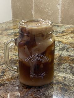 a glass jar filled with liquid sitting on top of a counter