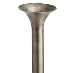 a tall metal vase sitting on top of a table