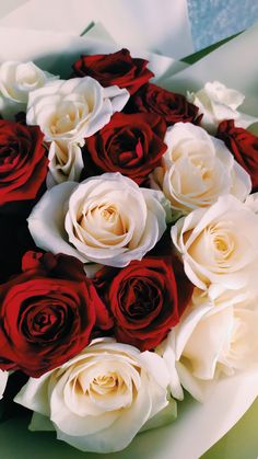 a bouquet of white and red roses