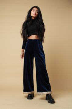 "PLEASE NOTE - Due to these trousers being handmade please allow 14-21 working days to be made and sent. The blue velvet trim trousers feature a soft 4 way stretch fabric, elasticated waistband, cropped wide leg complete with an embellished trimming. Lightweight and versatile, perfect to pair with a cosy jumper for those winter adventures or a sparkly halter for those festival adventures.  Trousers available in sizes 4,6,8,10,12,14,16,18,20: UK 4 - Waist 21\"- 22\", Hip 34\",  UK 6 - Waist 23\" Stretch Velvet Pants For Night Out, Full Length Velvet Stretch Bottoms, Stretch Velvet Full-length Bottoms, Stretch Velvet Full Length Bottoms, Stretch Velvet Pants For Party, Stretch Velvet Party Pants, Velvet High-waisted Pants For Party, Velvet High-waisted Party Pants, Chic Velvet Trousers