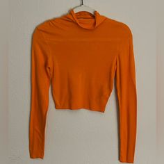 An Orange, Long-Sleeved, Turtle Neck Crop Top; Runched Design Across Both Shoulders, Runs Smaller; Never Worn Basic Fitted Long Sleeve Top For Spring, Fitted Long Sleeve Top For Fall, Solid Color Cropped Long Sleeve Top For Fall, Orange Stretch Long Sleeve Sweater, Orange Long Sleeve Stretch Sweater, Casual Stretch Orange Blouse, Casual Orange Stretch Blouse, Trendy Long Sleeve Orange Top, Basic Long Sleeve Sweater For Spring