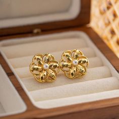 Introducing our stunning Hollow Flower Shaped Stud Earrings, meticulously crafted from durable stainless steel and elegantly adorned with an 18K gold plating. These earrings are a perfect blend of classic charm and modern sophistication, designed to add a touch of glamour to any ensemble. Whether you're attending a wedding, celebrating an anniversary, or simply dressing up for a gala, these earrings are sure to elevate your look. Key Features Material Excellence: Crafted from high-quality stainless steel, ensuring durability and longevity. Luxurious Finish: Enhanced with 18K gold plating for a radiant sheen that captures attention. Waterproof Design: Wear them confidently on any occasion without the fear of damage from water exposure. Hypoallergenic: Free from nickel, lead, and cadmium, ma Elegant Hypoallergenic Metal Flower Earrings, Gift Gold Flower Earrings Tarnish Resistant, Gold Flower Pearl Earrings For Gift, Gold Tarnish-resistant Flower Earrings For Gift, Tarnish Resistant Gold Plated Flower Earrings, Gold Flower-shaped Pearl Earrings As Gift, Gold Tarnish-resistant Flower Earrings Perfect For Gifts, Gold Floral Pearl Earrings For Gifts, Elegant Gold Hypoallergenic Flower Earrings