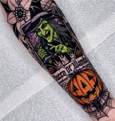 a halloween themed tattoo on the arm