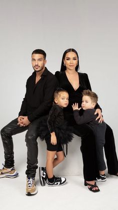 the family is posing for a photo in front of a sign that says, you are not