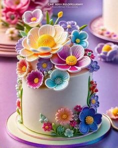 there is a cake decorated with flowers on the table