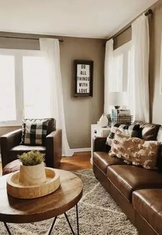 a living room with couches, chairs and a coffee table in front of a window