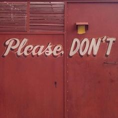 a red building with the words please don't painted on it