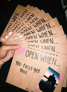 someone is holding up some cards with the words open when you first get this