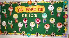 a green bulletin board with smiley faces and words that say, you make me smile