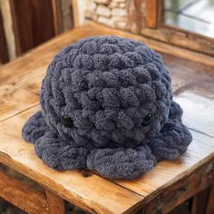 an octopus stuffed animal sitting on top of a wooden table