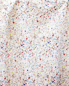 a white sheet covered in lots of different colored sprinkles