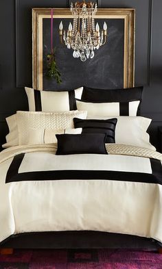 black and white bedding in a bedroom with chandelier