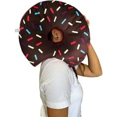 a woman with a donut shaped pillow on her head