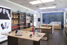 the inside of a cell phone store with many items on tables and shelves in front of them