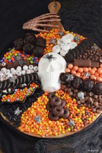 a halloween cake decorated with chocolate, candy and sprinkles