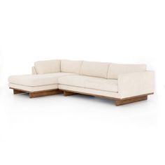 a white couch sitting on top of a wooden table