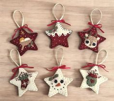 four ornaments are hanging on a table