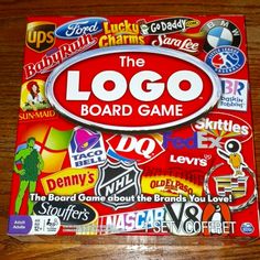 the logo board game is sitting on top of a wooden table with stickers all over it