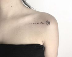 a woman with a tattoo on her shoulder that reads cursive and the word cursive