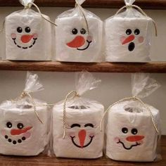 some bags with faces drawn on them sitting on a shelf