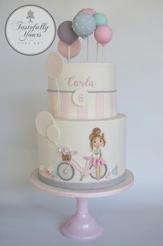 a three tiered cake decorated with balloons and a girl riding a bike on top