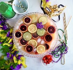 a platter filled with lemons and grapefruit on top of a table