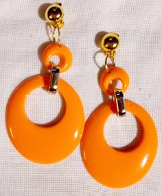 These are unique  Handmade  Only 1 available  Orange and gold acrylic hoops They hang 3 inches  These are very lightweight on the ear Sturdy clip on closure  They are one of a kind Cheap Orange Retro Earrings, Retro Clip-on Hoop Earrings, 80s Memories, Collection Ideas, Orange And Gold, Dec 12, Only 1, Chicago Il, Clip On