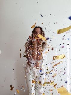 a woman standing in front of confetti and streamers