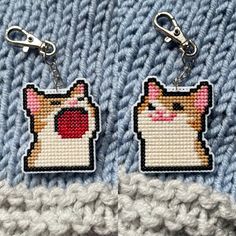 two key chains that have pictures of cats on them