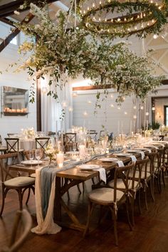 an elegant wedding reception with greenery and candles