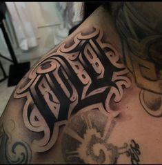 the back of a man's upper half covered in tattoos