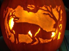 a carved pumpkin with an animal on it