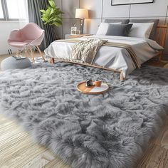 a bedroom with a bed, chair and rug on the floor