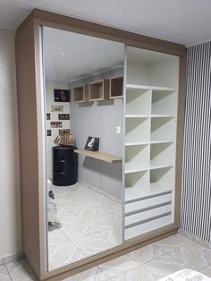 a room that has a large mirror on the wall and shelves in front of it