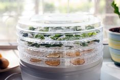 several trays filled with food sitting on top of a table next to a window