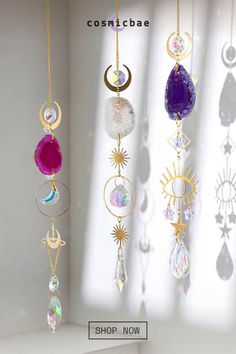 the sun and moon mobiles are hanging in front of a window with white curtains