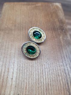 A beautiful pair of 1950s gold tone and faux emerald clip on earrings by Sphinx. They measure 1.9cm L x 1.3cm W.  They have some minor wear in the form of surface marks and mild patina to metal but overall good considering they are over 70 years old. If you have any questions please feel free to drop me a message:) Please note the postage cost to USA reflects tracked postage and can take up to 14 days. Classic Green Clip-on Earrings, Green Clip-on Earrings For Formal Occasions, Green Clip-on Metal Earrings, Classic Green Clip-on Earrings For Formal Occasions, Green Clip-on Formal Earrings, Green Oval Clip-on Earrings, Oval Green Clip-on Earrings, Vintage Hallmarked Green Earrings, Retro Green Clip-on Earrings