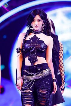 a woman in black outfit with chains on her waist