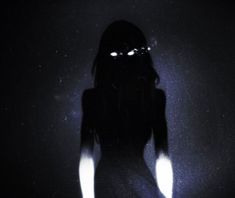 the silhouette of a woman with glowing eyes and long hair is shown against a dark background